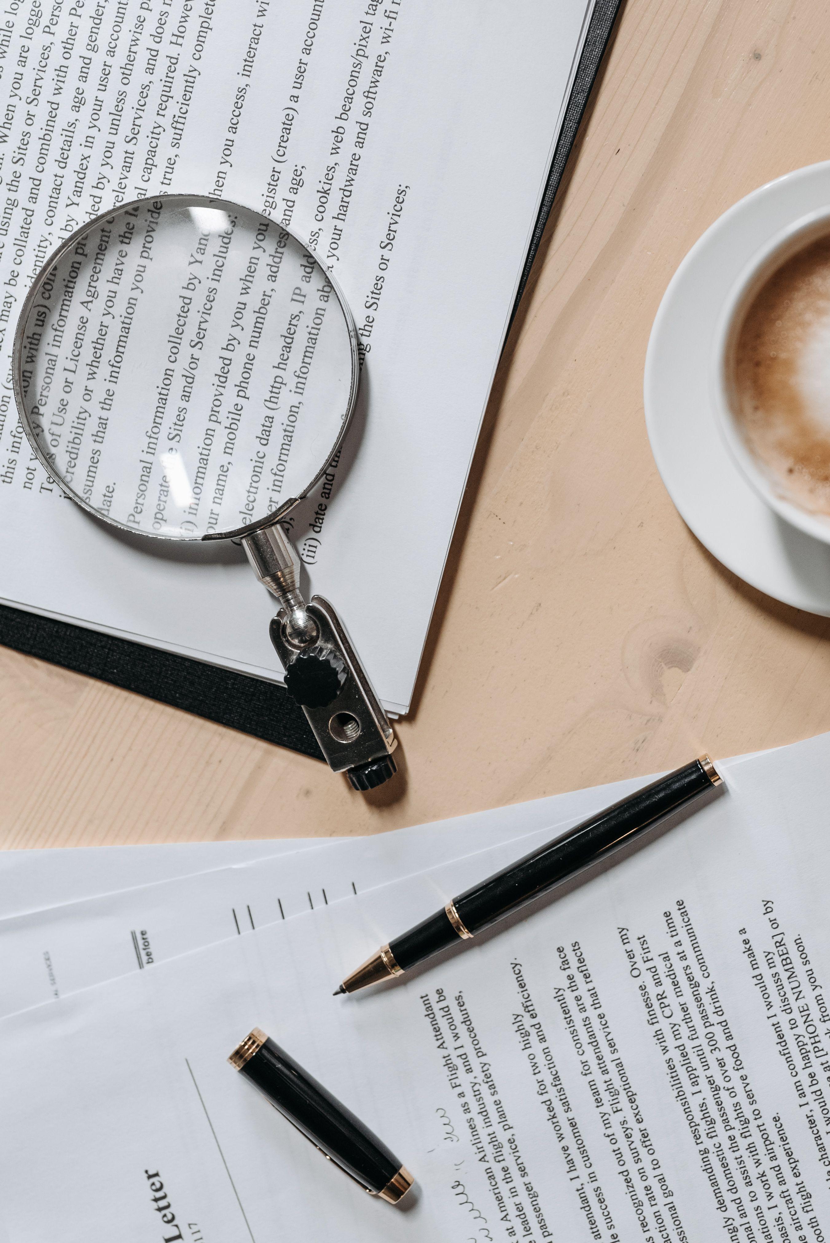 Legal documents under a magnifying glass on a desk — expert review and LAA rate scrutiny